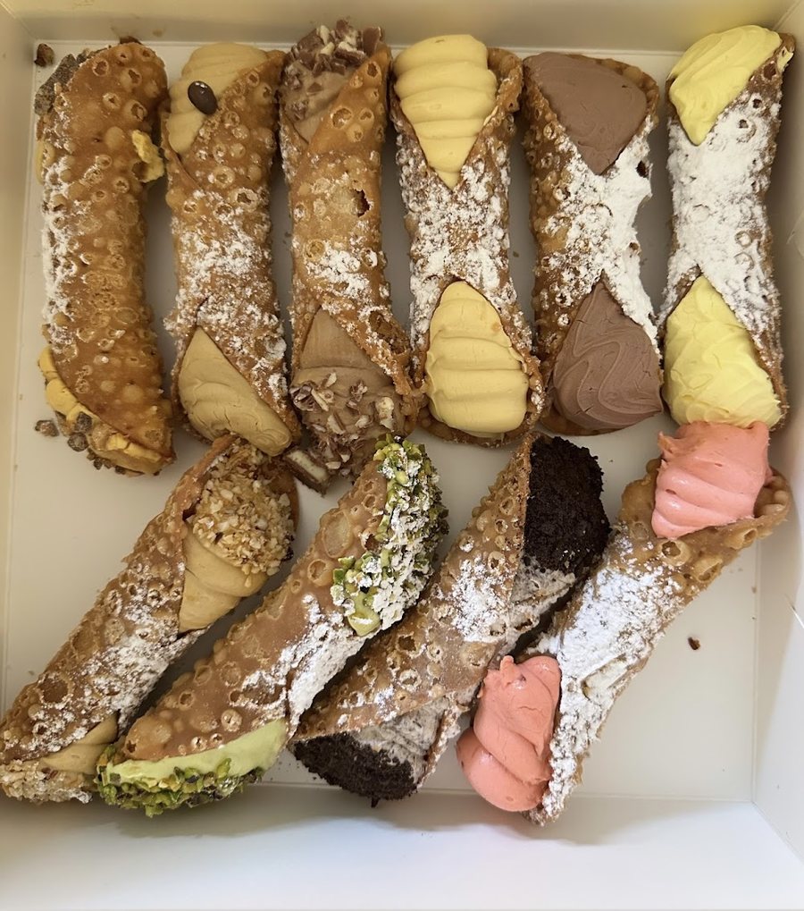 A box of ten cannoli with different fillings