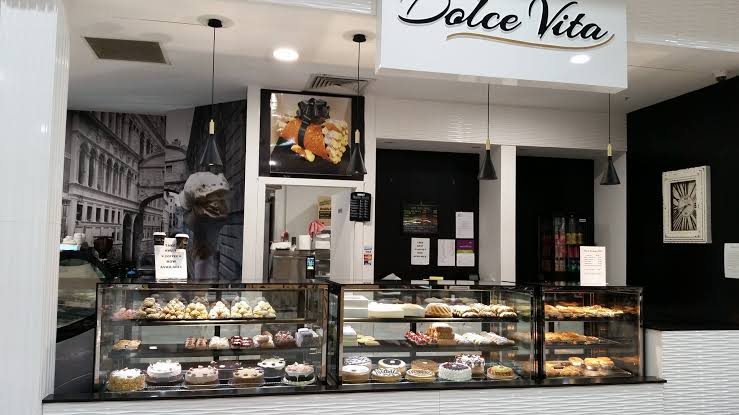 The Dolce Vita shopfront at Carnes Hill Marketplace, with glass cabinets full of cakes and pastries